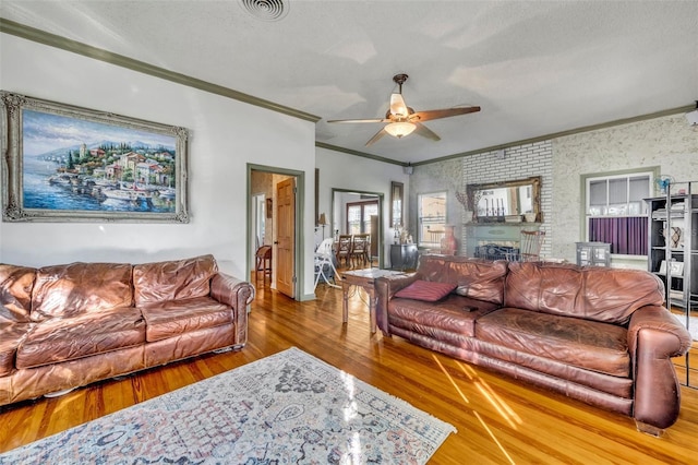 living room with crown molding, ceiling fan, and hardwood / wood-style flooring