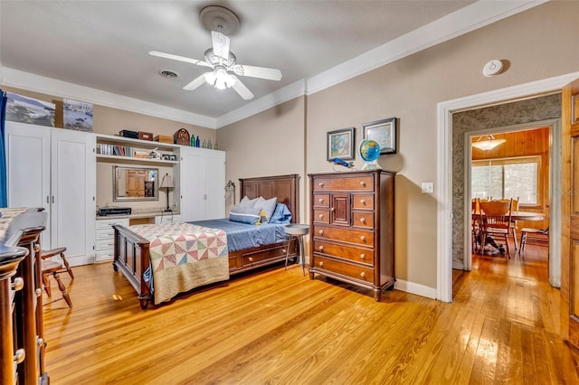 bedroom with ceiling fan, light hardwood / wood-style floors, and ornamental molding