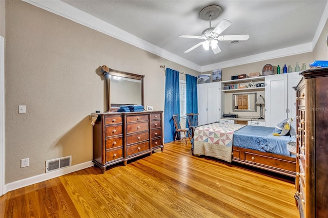 bedroom with ceiling fan, crown molding, and light hardwood / wood-style flooring