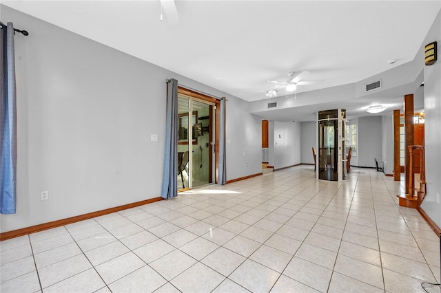 spare room featuring light tile patterned floors and ceiling fan