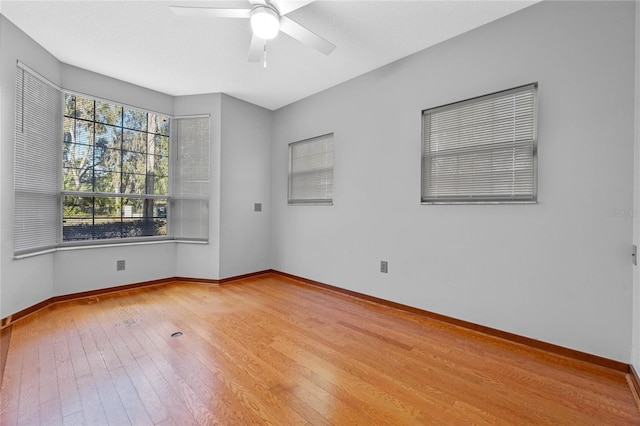 empty room with ceiling fan and light wood-type flooring