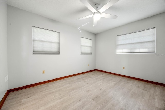 unfurnished room with light hardwood / wood-style floors and ceiling fan