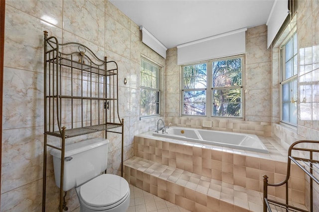 bathroom featuring tile patterned floors, tile walls, and toilet