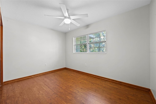 unfurnished room with ceiling fan, wood-type flooring, and a textured ceiling