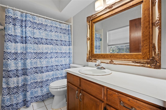 bathroom with tile patterned flooring, vanity, and toilet