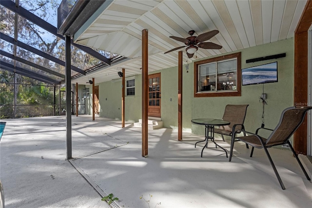 view of patio / terrace with ceiling fan and glass enclosure