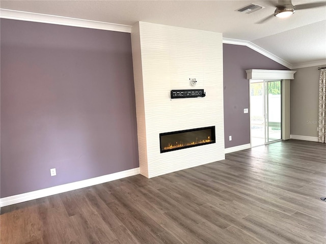 unfurnished living room featuring ceiling fan, dark wood-type flooring, crown molding, lofted ceiling, and a fireplace