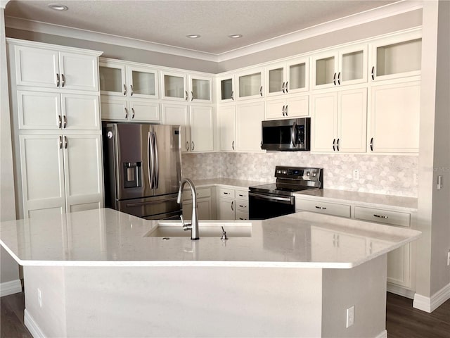 kitchen featuring a large island, sink, light stone counters, and appliances with stainless steel finishes