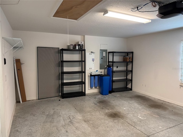 garage featuring electric panel and a garage door opener