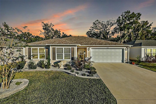 view of front of house featuring a yard and a garage