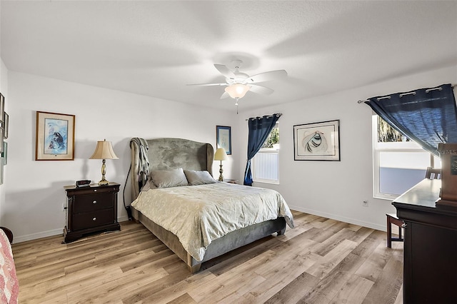 bedroom with ceiling fan and light wood-type flooring