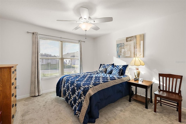 bedroom featuring ceiling fan and light carpet