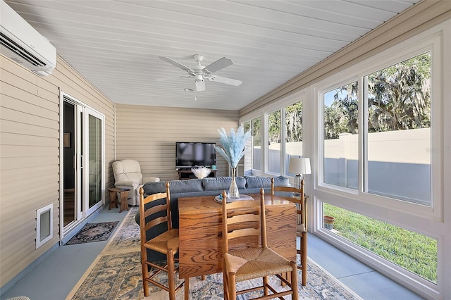 sunroom with a wall unit AC, plenty of natural light, and ceiling fan