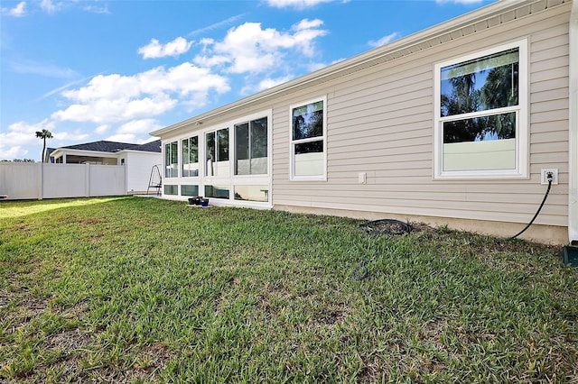 rear view of house featuring a lawn