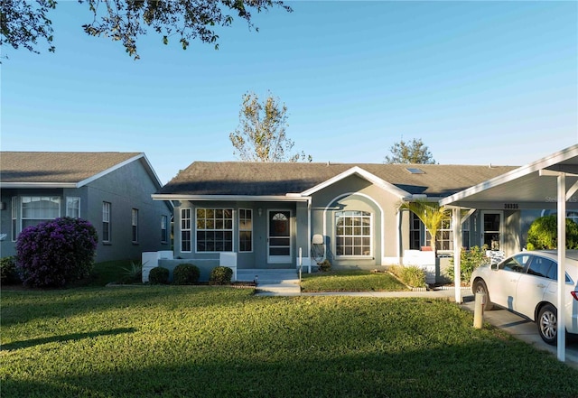 single story home featuring a carport and a front lawn