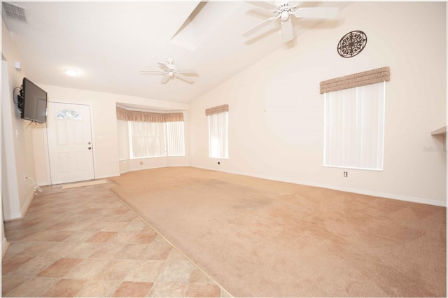 carpeted empty room with ceiling fan and vaulted ceiling