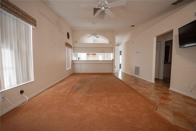 interior space with light carpet, vaulted ceiling, and ceiling fan