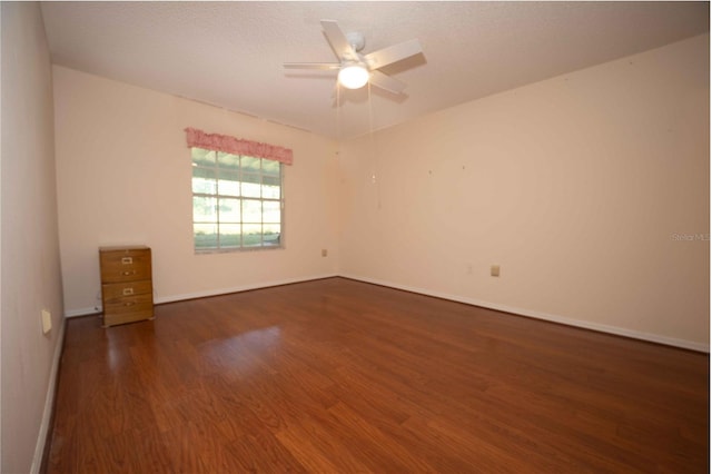 unfurnished room featuring dark hardwood / wood-style flooring and ceiling fan