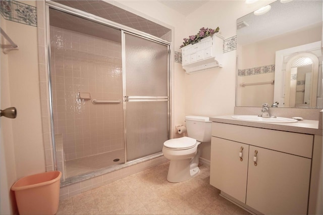 bathroom with vanity, toilet, and walk in shower