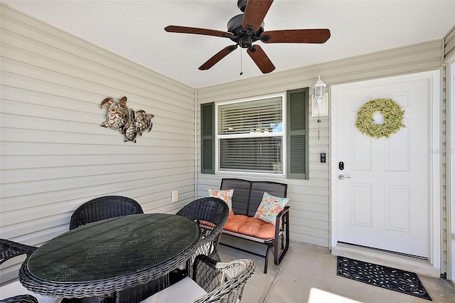 entrance to property with ceiling fan and covered porch