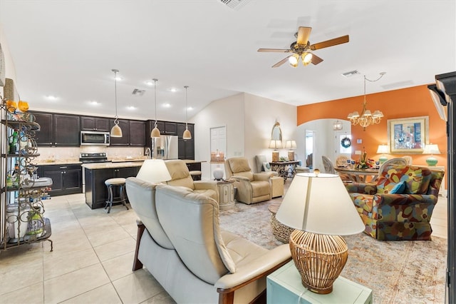 living room featuring lofted ceiling, sink, light tile patterned floors, and ceiling fan with notable chandelier