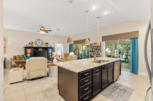 kitchen with light stone counters, stainless steel dishwasher, ceiling fan, sink, and decorative light fixtures