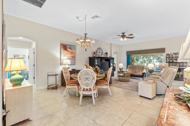 dining room featuring light tile patterned floors and ceiling fan with notable chandelier