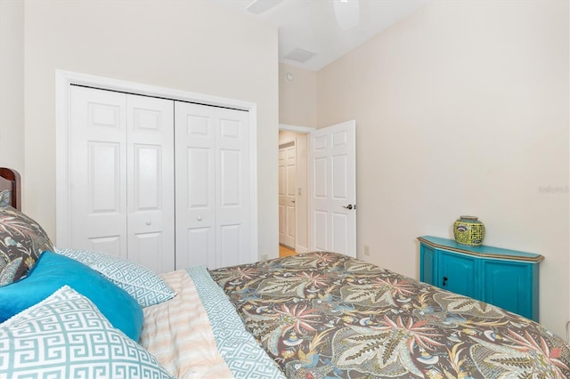 bedroom with ceiling fan and a closet