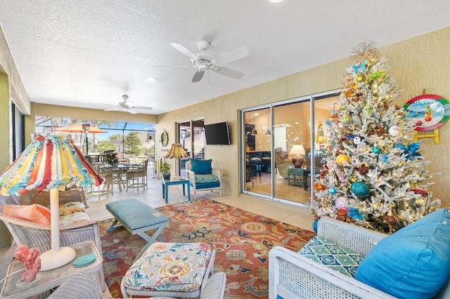 tiled living room with ceiling fan and a textured ceiling