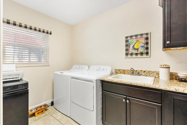 laundry area with sink, light tile patterned floors, and independent washer and dryer