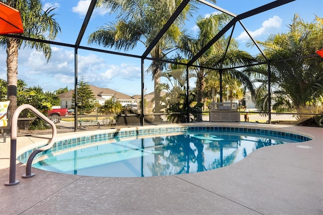 view of swimming pool with a patio and glass enclosure