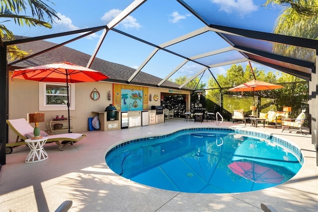 view of pool with area for grilling, a patio, and glass enclosure