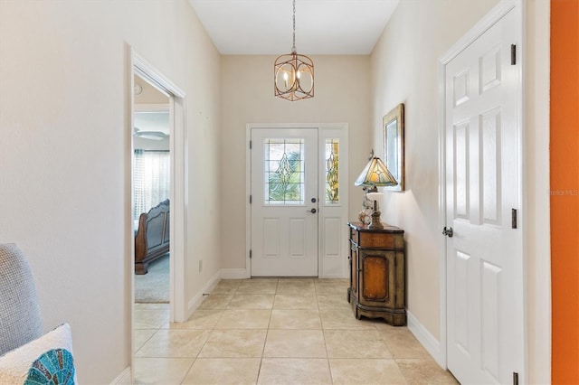 tiled entrance foyer with an inviting chandelier