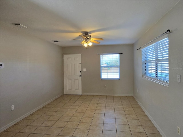 unfurnished room featuring ceiling fan and light tile patterned floors