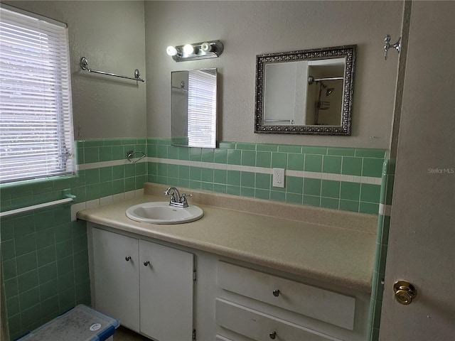 bathroom featuring vanity, tile walls, and a healthy amount of sunlight