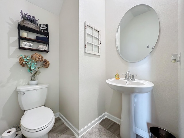 bathroom featuring hardwood / wood-style floors and toilet