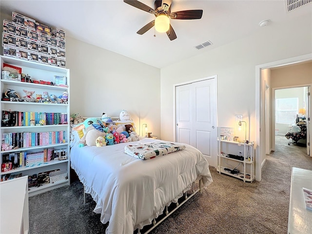 bedroom featuring ceiling fan, dark carpet, and a closet