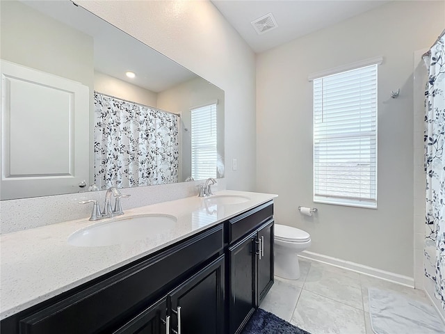 bathroom with tile patterned floors, vanity, a shower with shower curtain, and toilet