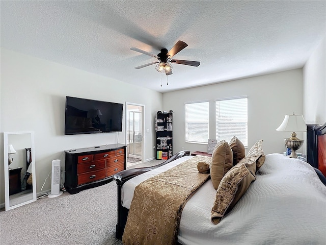 bedroom with carpet flooring, a textured ceiling, connected bathroom, and ceiling fan