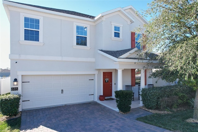 view of front of house with a porch and a garage