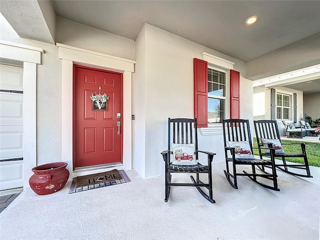 view of exterior entry with a porch