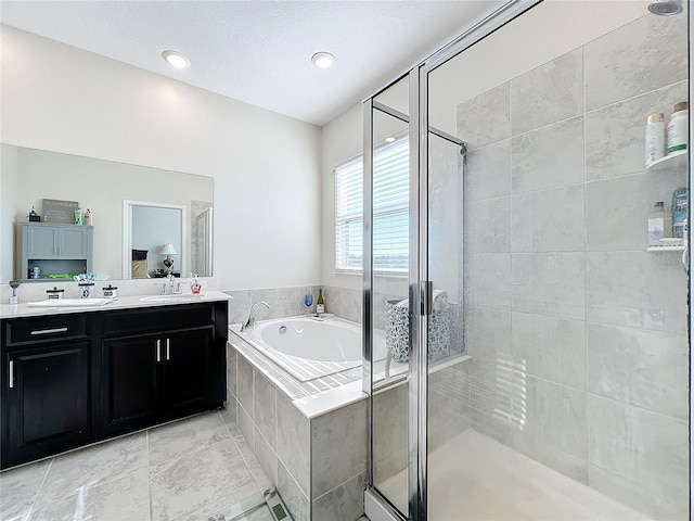 bathroom with tile patterned floors, vanity, and shower with separate bathtub