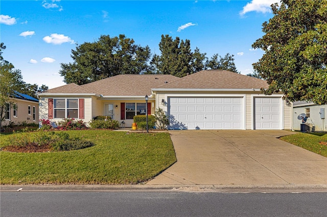 ranch-style house featuring a garage and a front yard