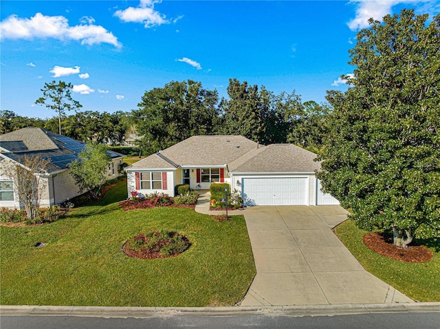 ranch-style home with a garage and a front lawn