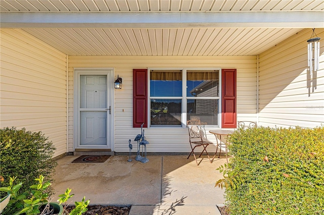 view of exterior entry with covered porch