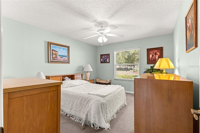 carpeted bedroom featuring a textured ceiling and ceiling fan