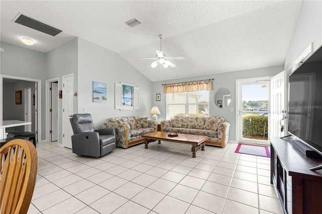 tiled living room featuring a textured ceiling, vaulted ceiling, and ceiling fan