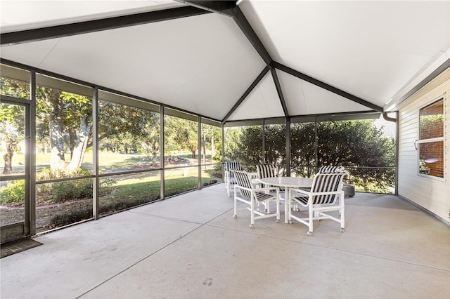 unfurnished sunroom with lofted ceiling with beams