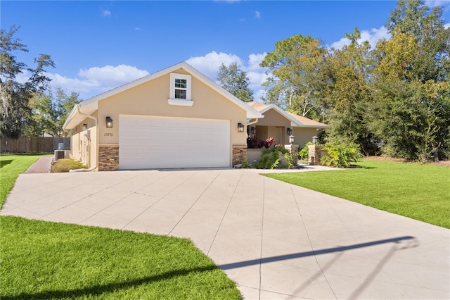 view of front of house featuring cooling unit, a front yard, and a garage