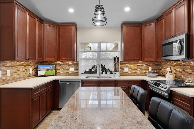 kitchen featuring stainless steel appliances, tasteful backsplash, a sink, and light stone counters